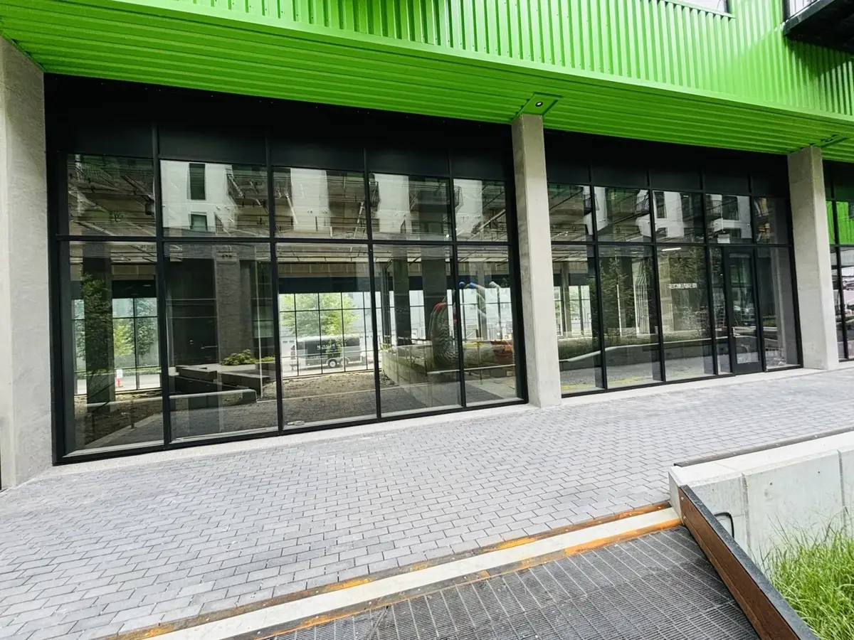 Aluminum Storefront Windows Under Green Canopy